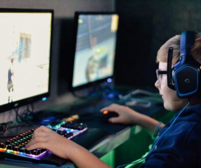 boy wearing headset playing computer game