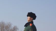 man standing beside leafless trees