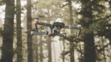 gray and black DJI Mavic Pro quadcopter drone on mid top air near forest at daytime
