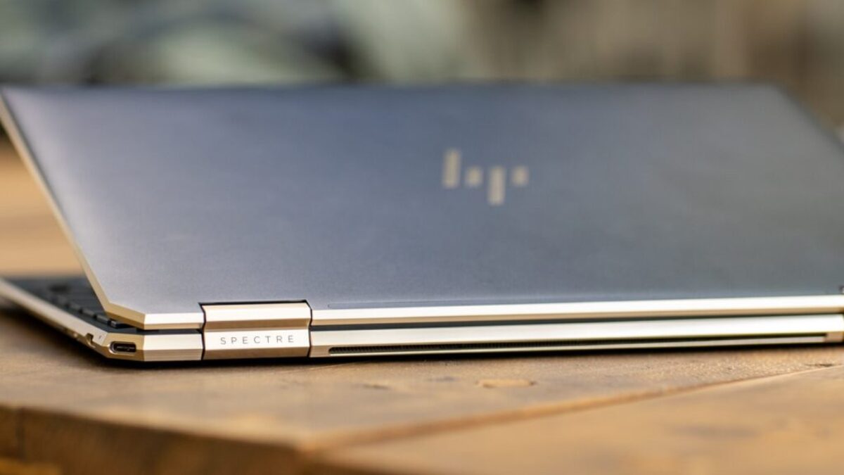 silver macbook on brown wooden table