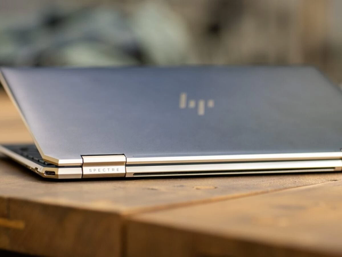 silver macbook on brown wooden table