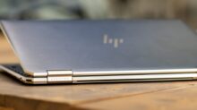 silver macbook on brown wooden table