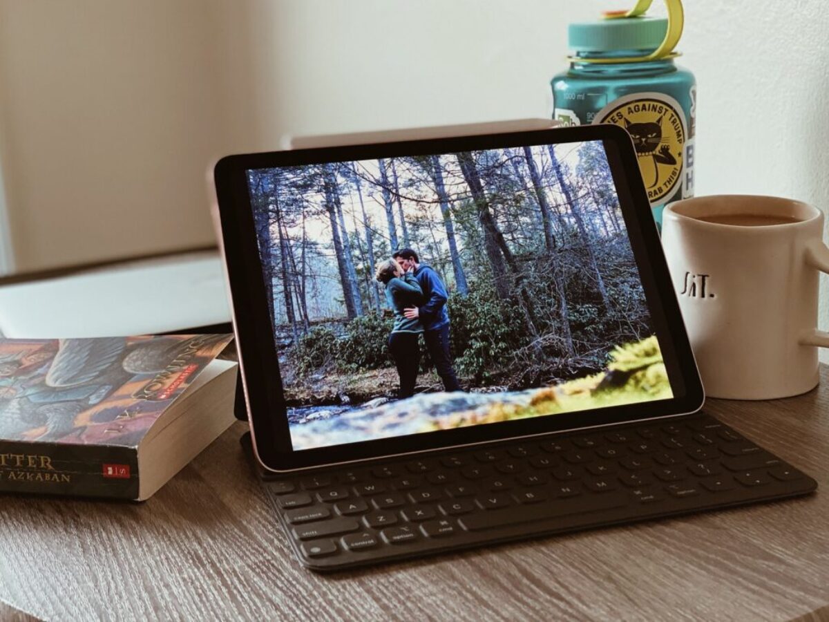 black ipad with keyboard on white table