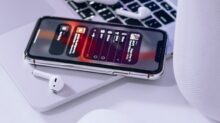 iPhone on Macbook beside magic mouse