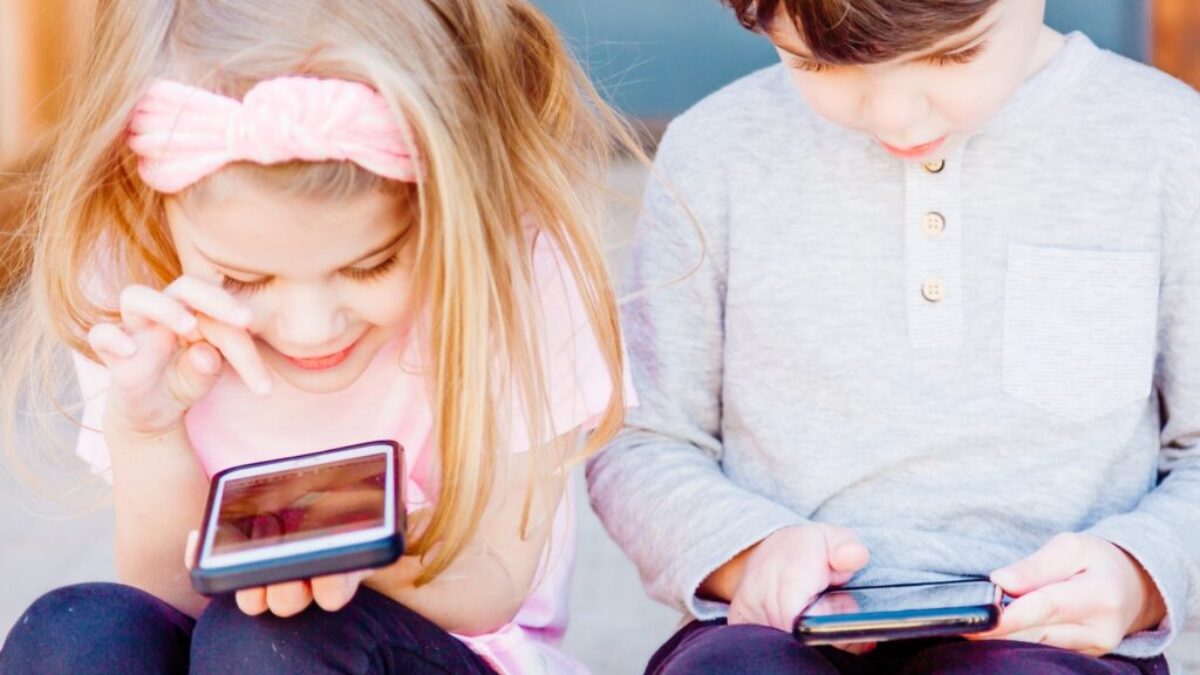 girl and boy using Android smartphones