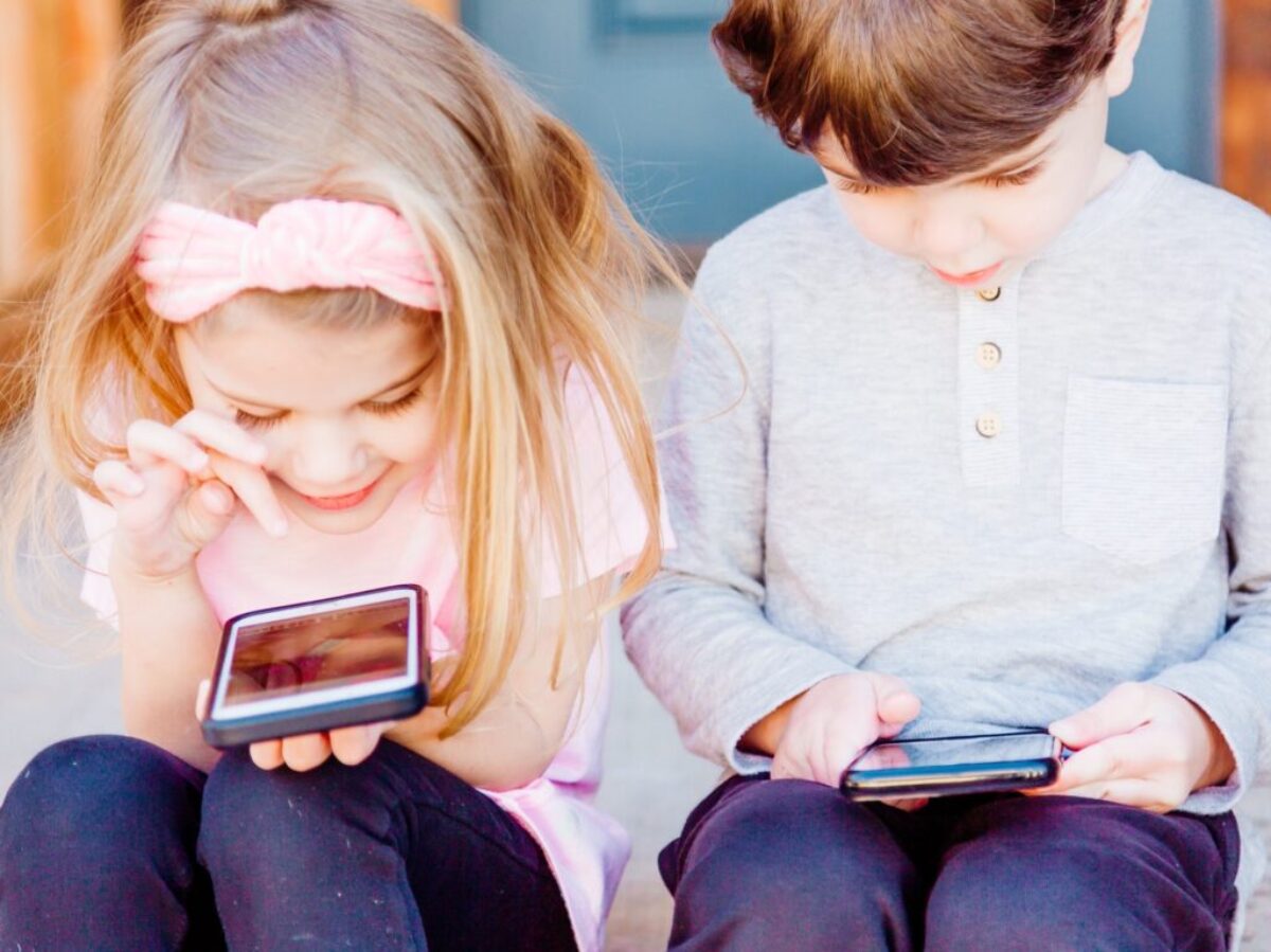 girl and boy using Android smartphones