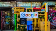 google logo beside building near painted walls at daytime