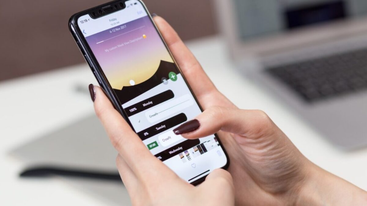 person hand holding iPhone X