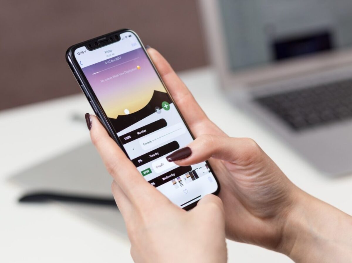 person hand holding iPhone X