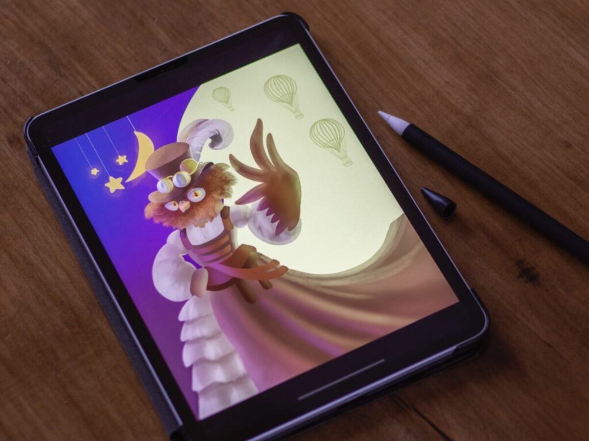 black tablet computer on brown wooden table