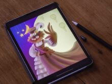black tablet computer on brown wooden table