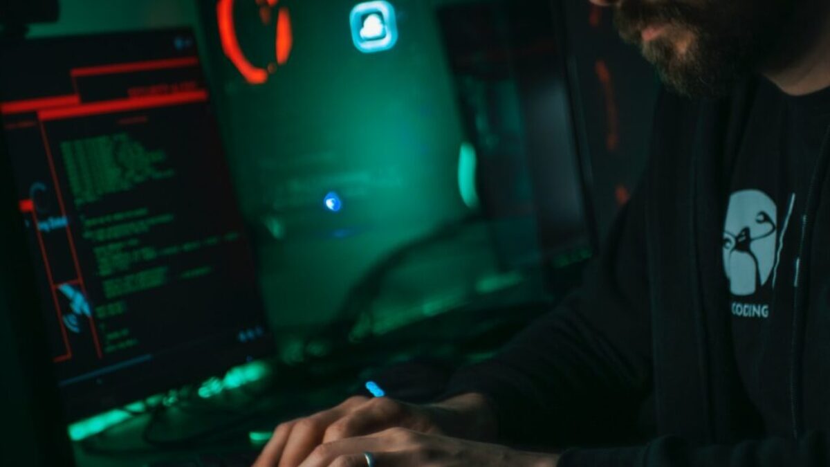 man in black jacket using computer