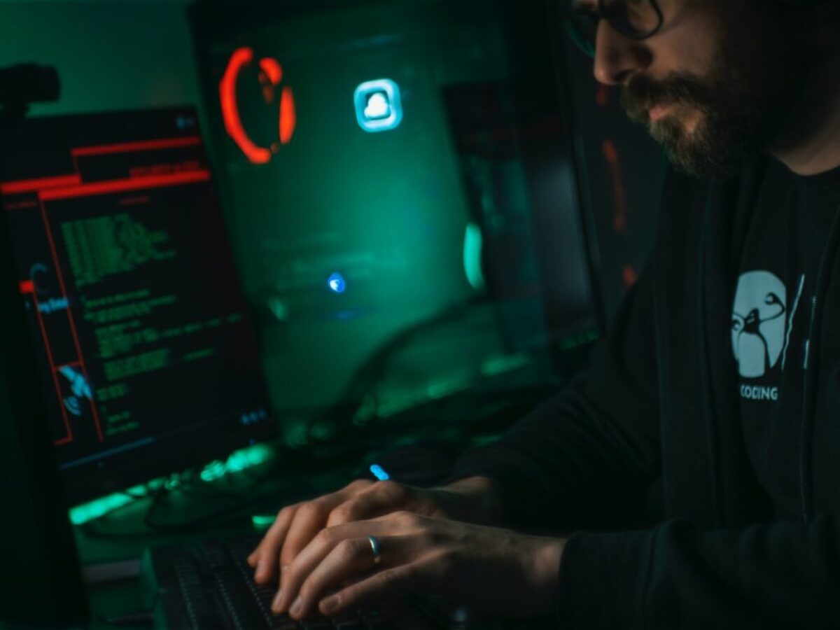 man in black jacket using computer