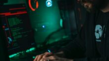 man in black jacket using computer