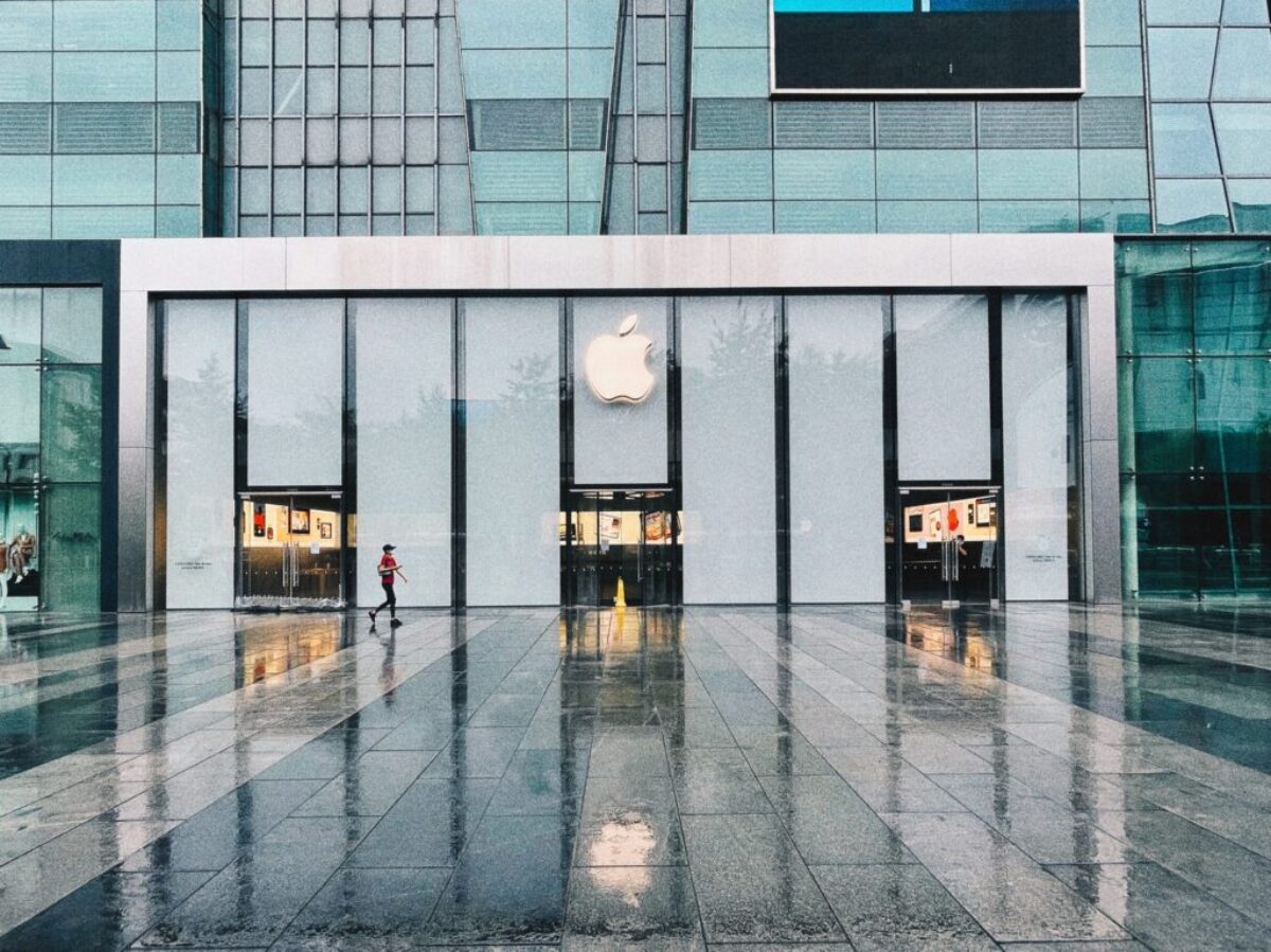 person in black jacket standing in front of glass window