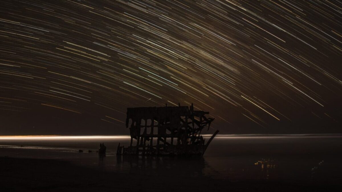 time lapse photography of house with shooting star at night time