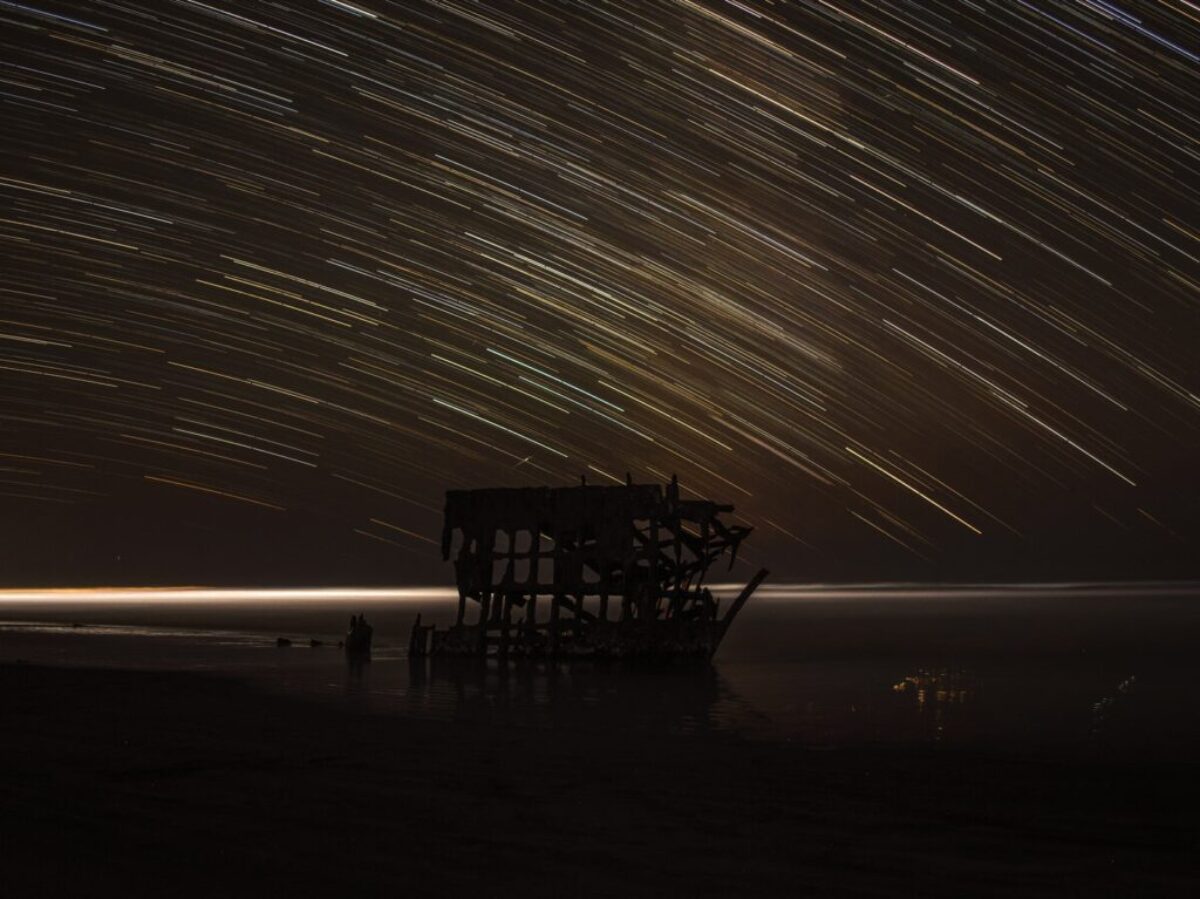 time lapse photography of house with shooting star at night time