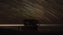 time lapse photography of house with shooting star at night time