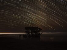 time lapse photography of house with shooting star at night time