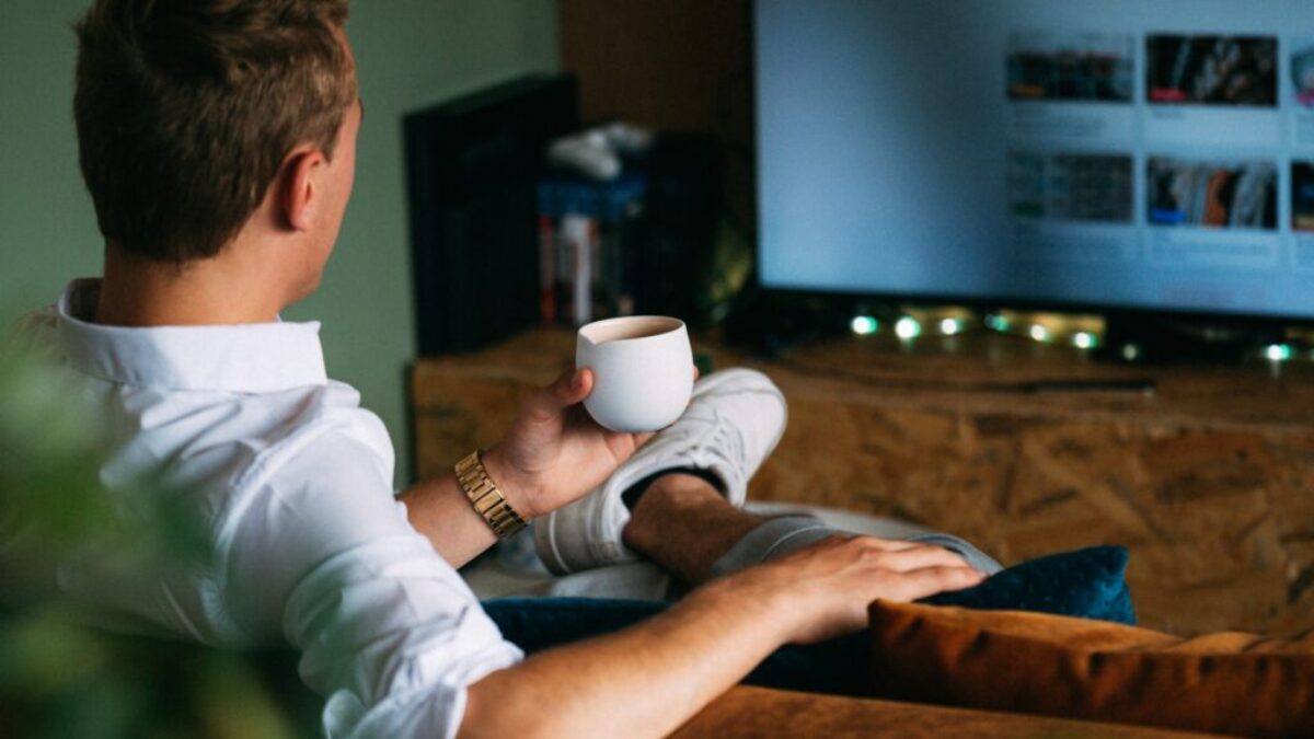 man in white dress shirt holding white ceramic mug