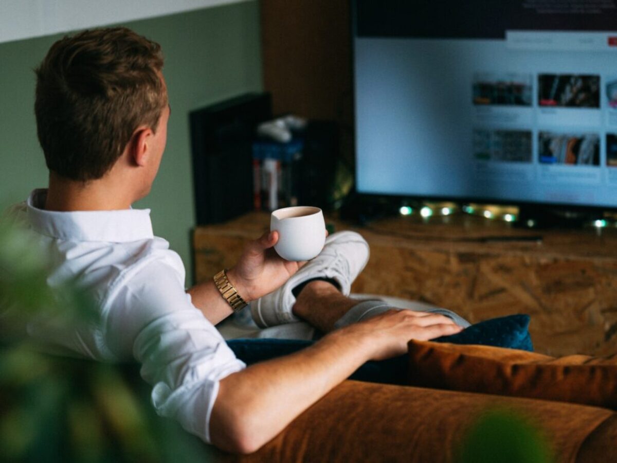 man in white dress shirt holding white ceramic mug