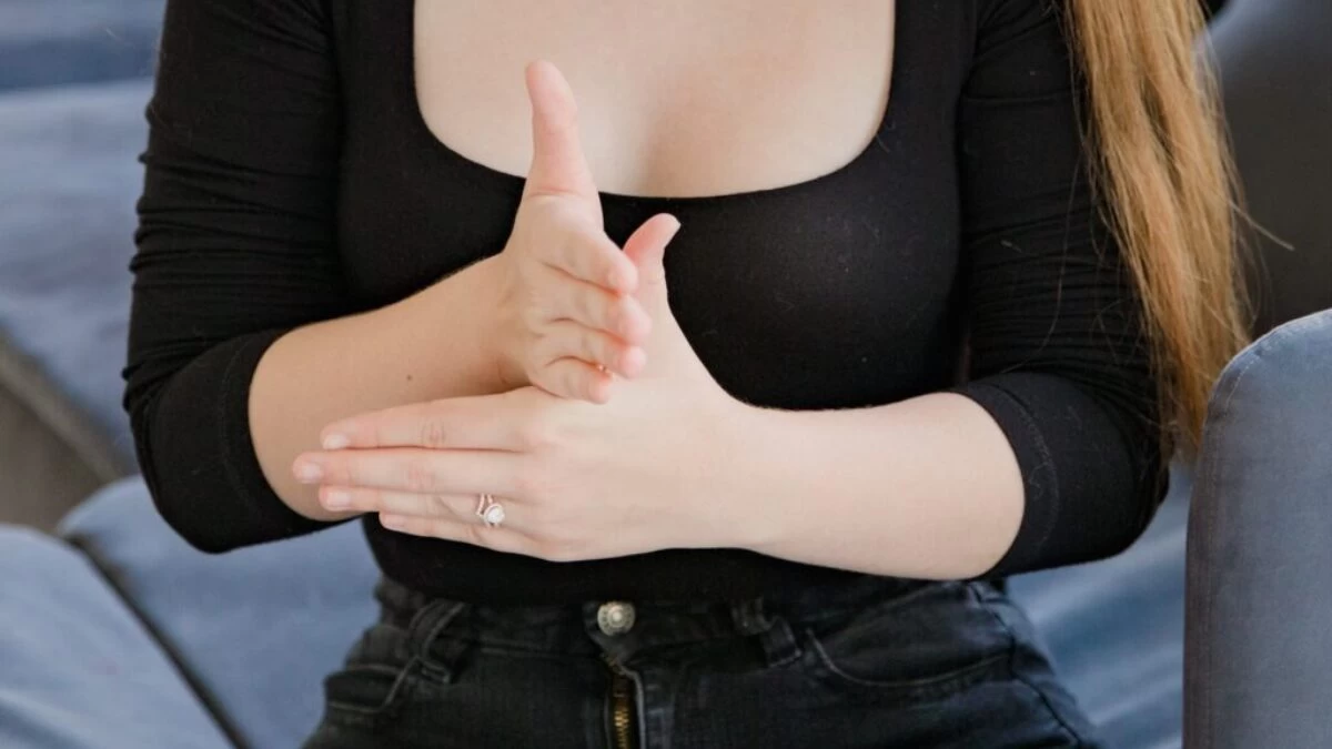 Midsection of Woman Showing Sign Language