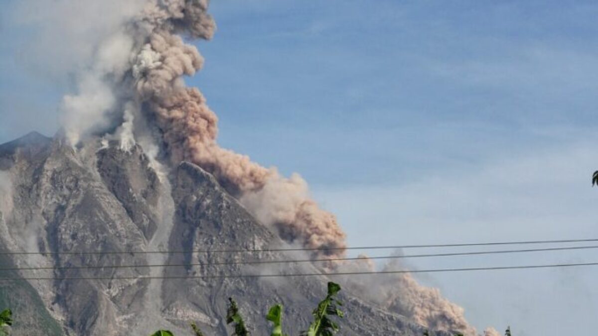 Erupting Volcano Under Blue Sunny Cloudy Sky