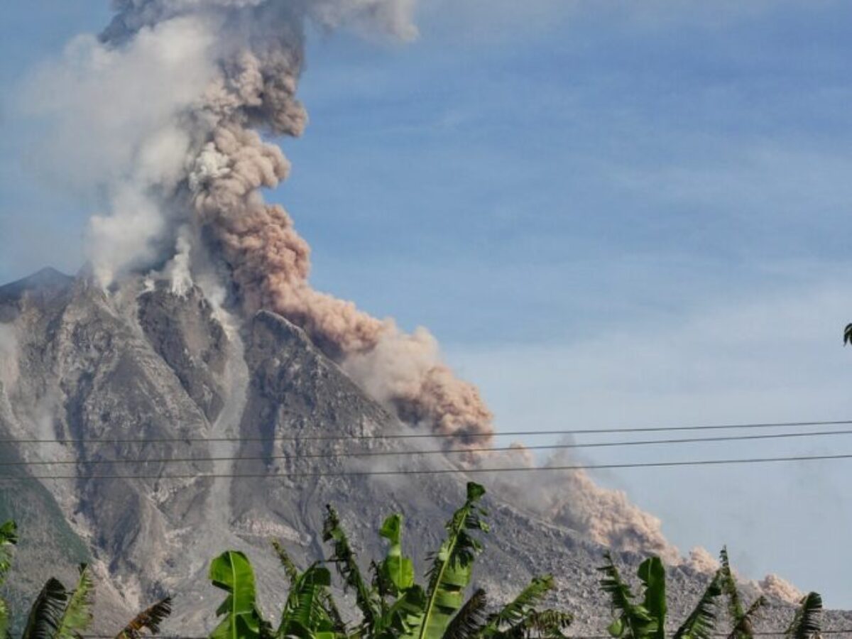 Erupting Volcano Under Blue Sunny Cloudy Sky