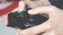 Man Holding Black Game Controller