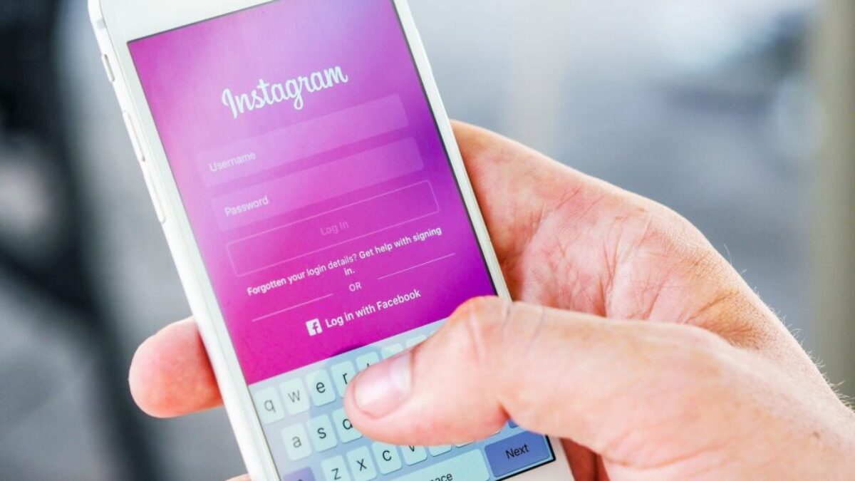 Person Holding Phone While Logging-in on Instagram Application
