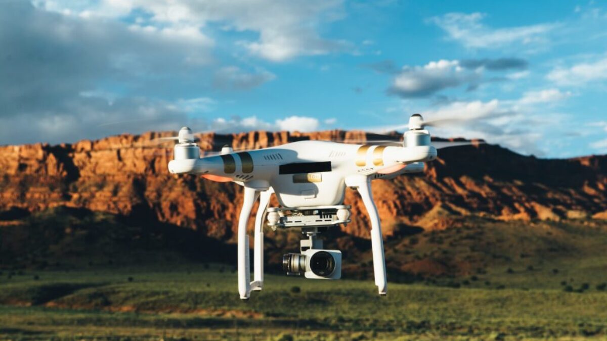 landscape photography of DJI Phantom flying midair in front of mountain