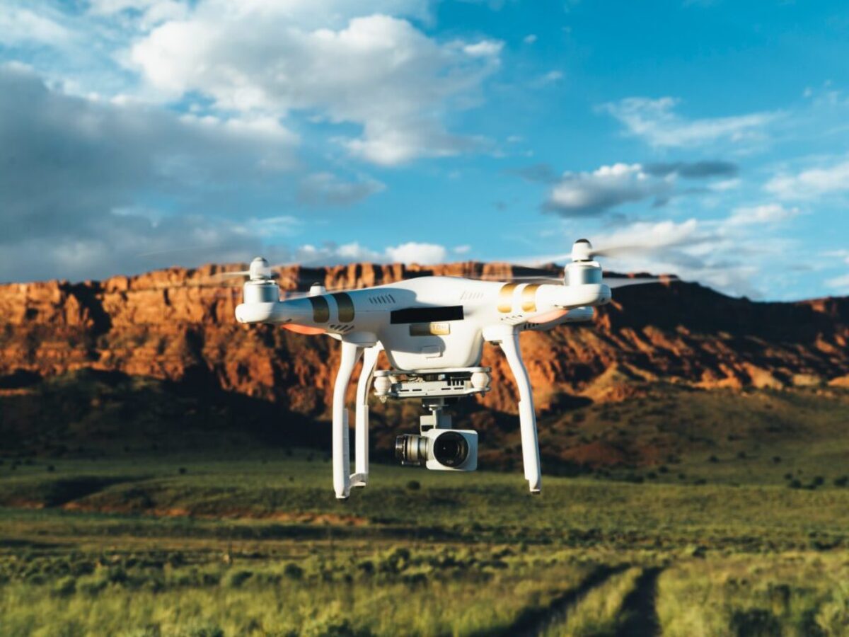 landscape photography of DJI Phantom flying midair in front of mountain