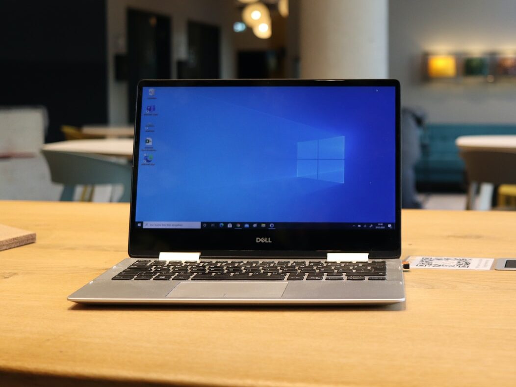 macbook pro on brown wooden table
