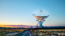 white radar telescope on grass field