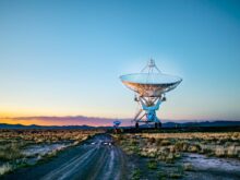 white radar telescope on grass field