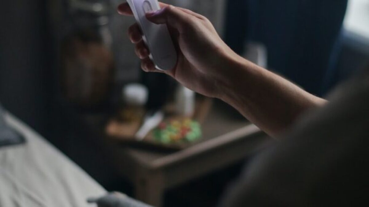 Person Holding White and Pink Plastic Tool