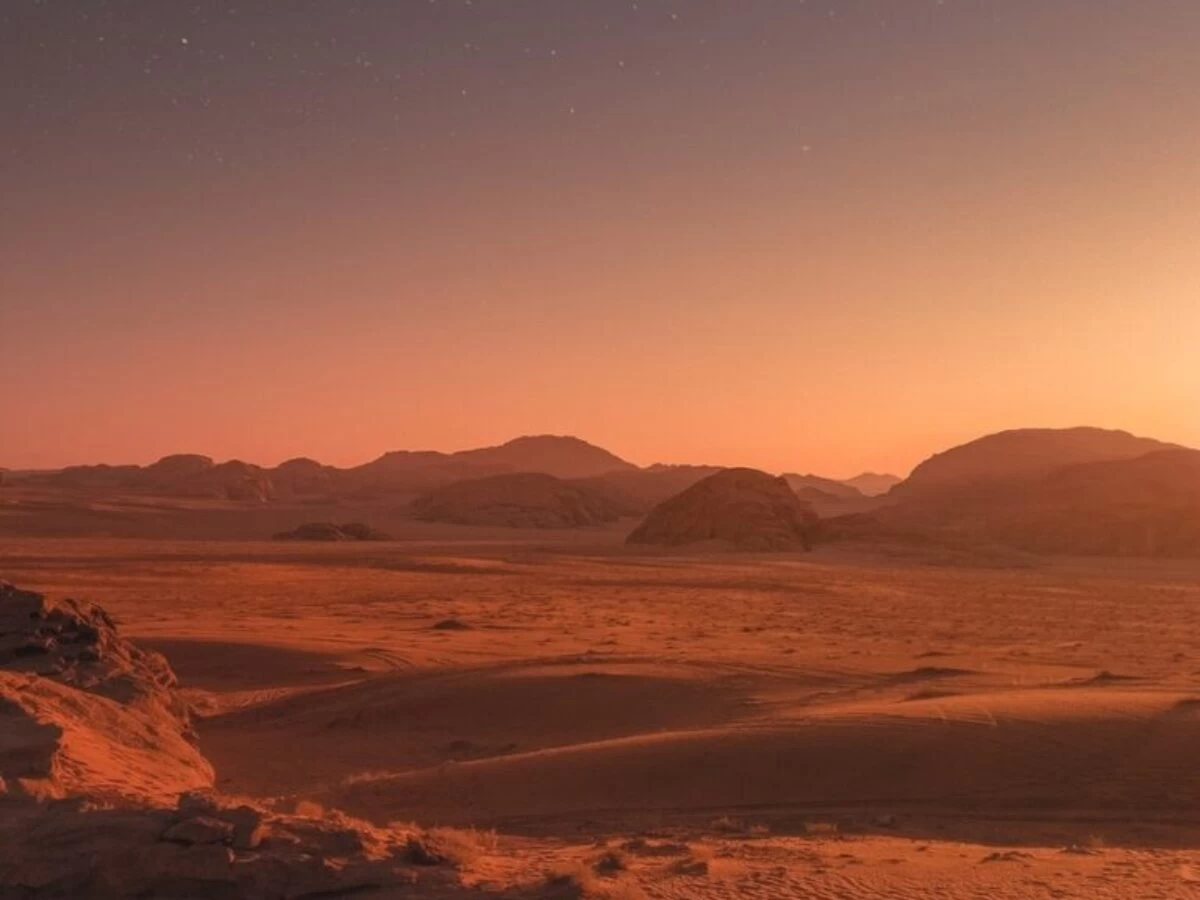 brown sand under blue sky during night time