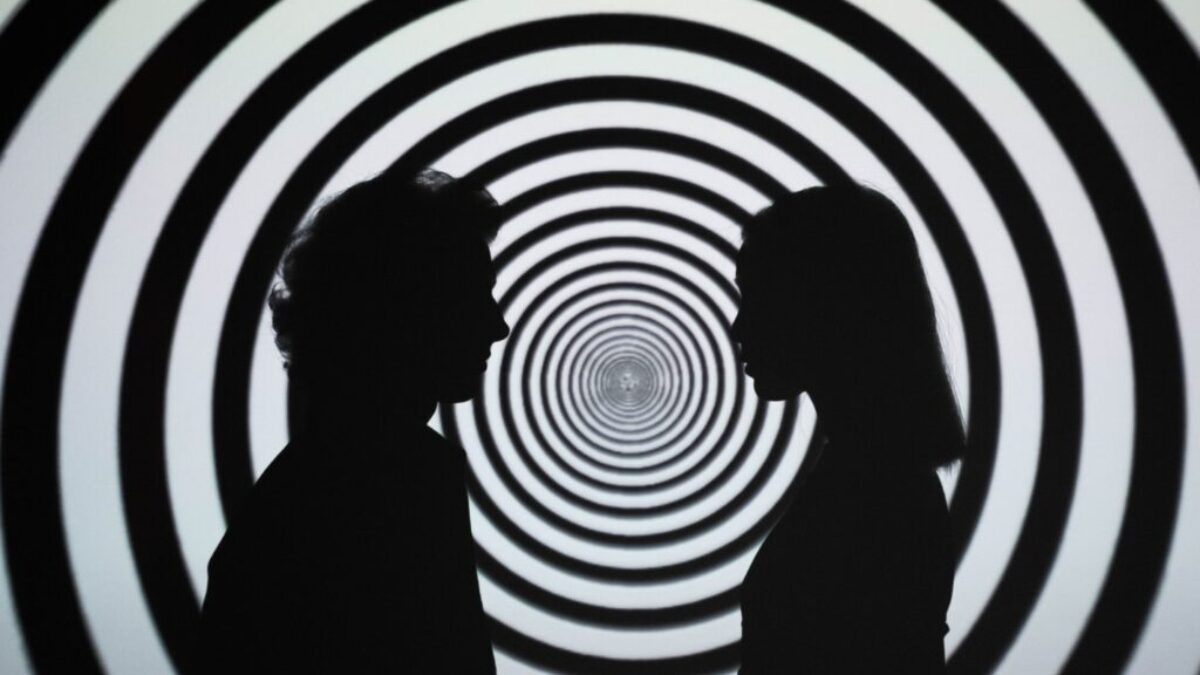 Silhouette of 2 Person Standing in Front of White and Black Stripe Wall
