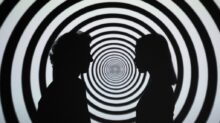 Silhouette of 2 Person Standing in Front of White and Black Stripe Wall