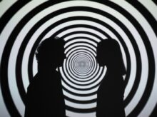 Silhouette of 2 Person Standing in Front of White and Black Stripe Wall
