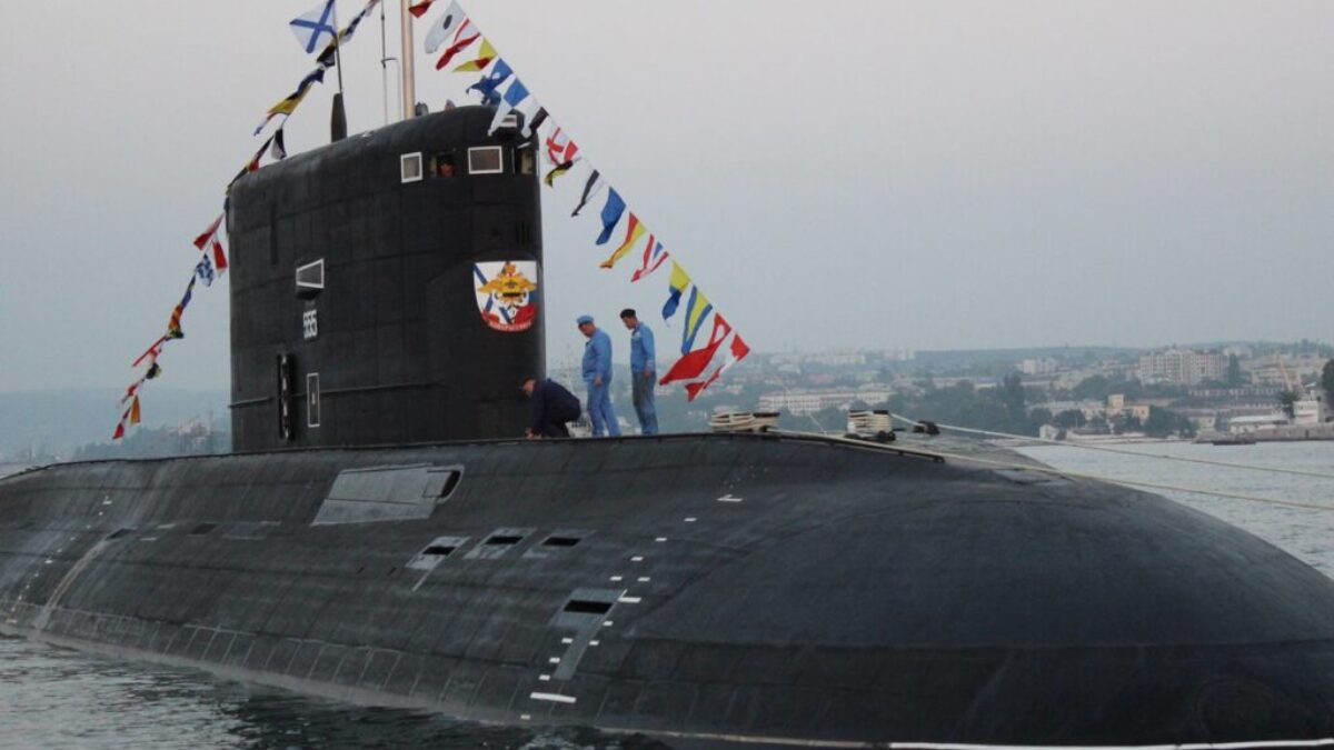 black ship on sea under gray sky during daytime