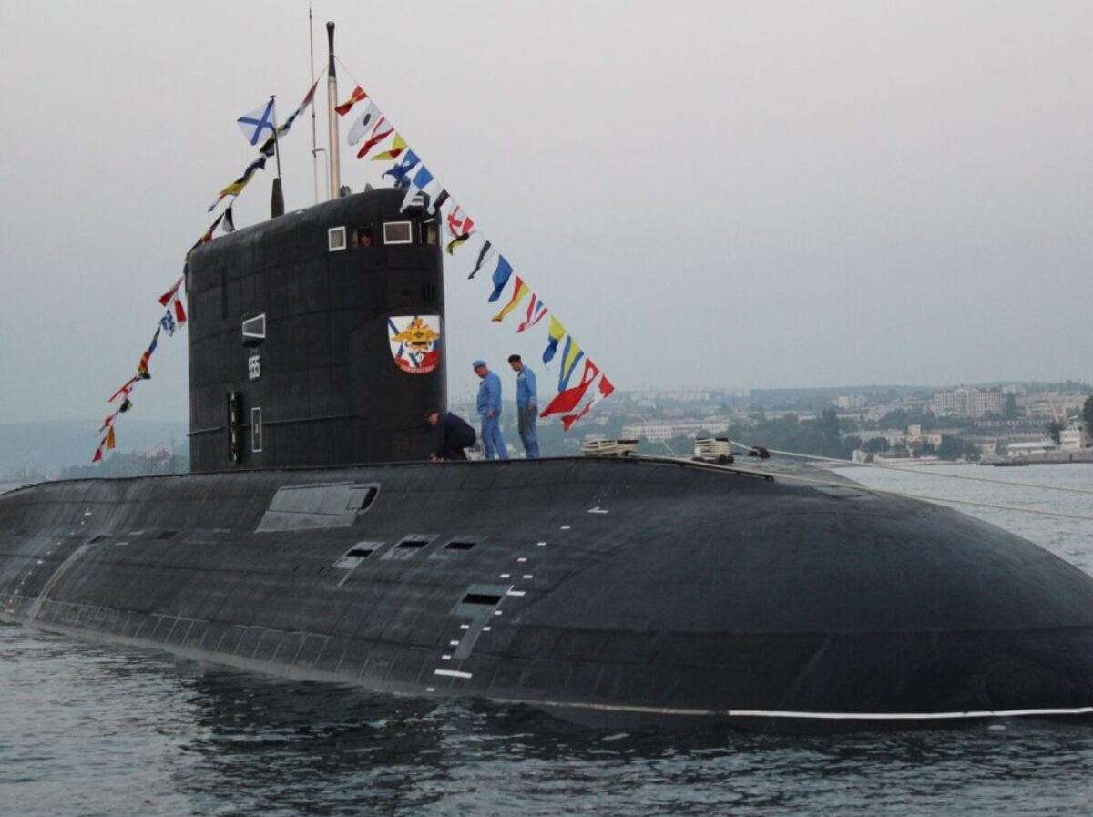 black ship on sea under gray sky during daytime