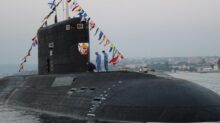 black ship on sea under gray sky during daytime