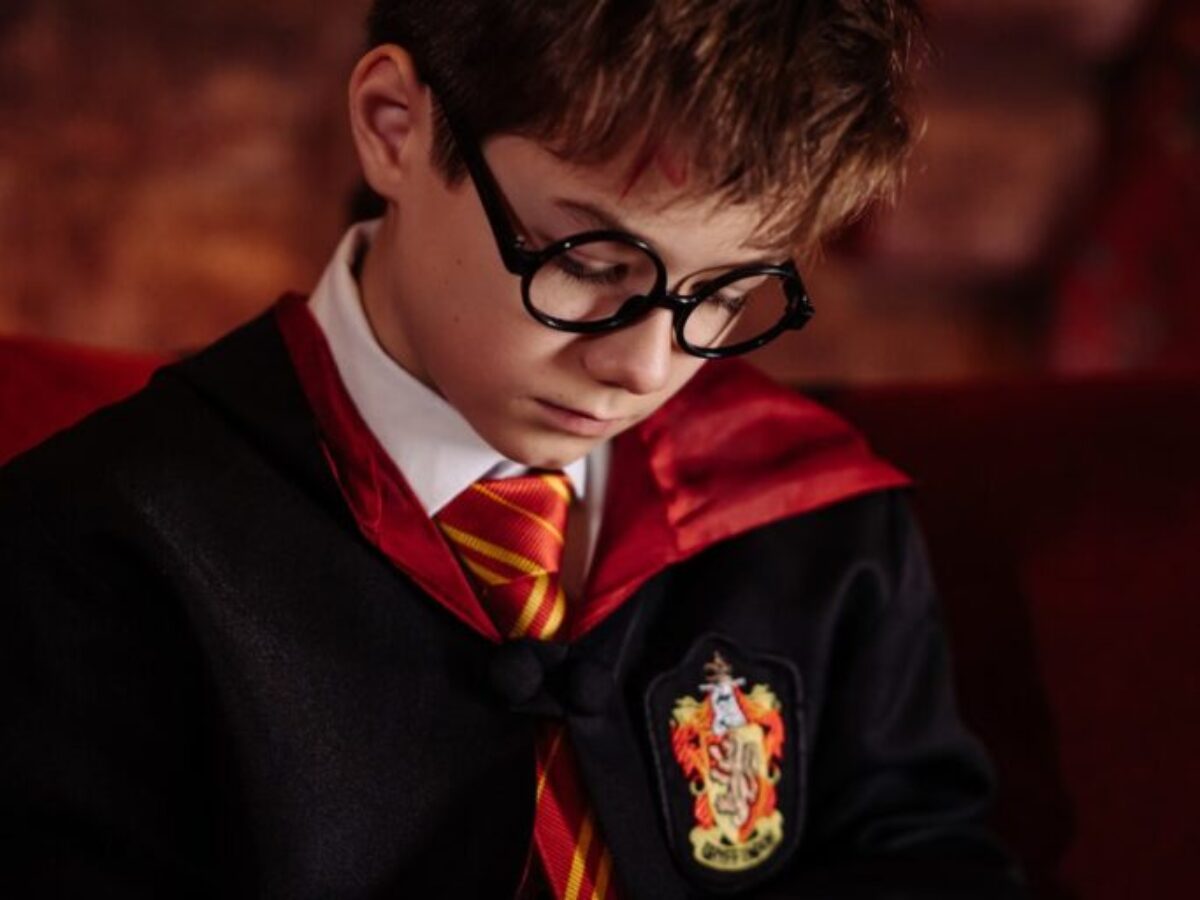 Boy in Black Framed Eyeglasses Reading a Book