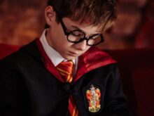 Boy in Black Framed Eyeglasses Reading a Book