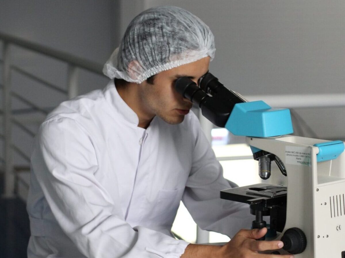 man sight on white microscope
