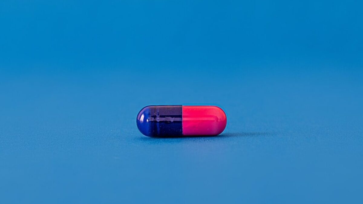 red and blue pill on blue surface