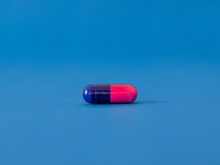 red and blue pill on blue surface