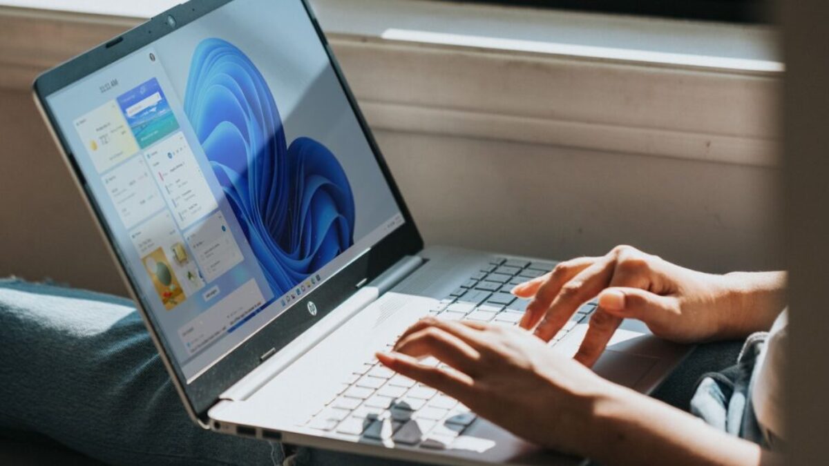 person using Windows 11 computer on lap