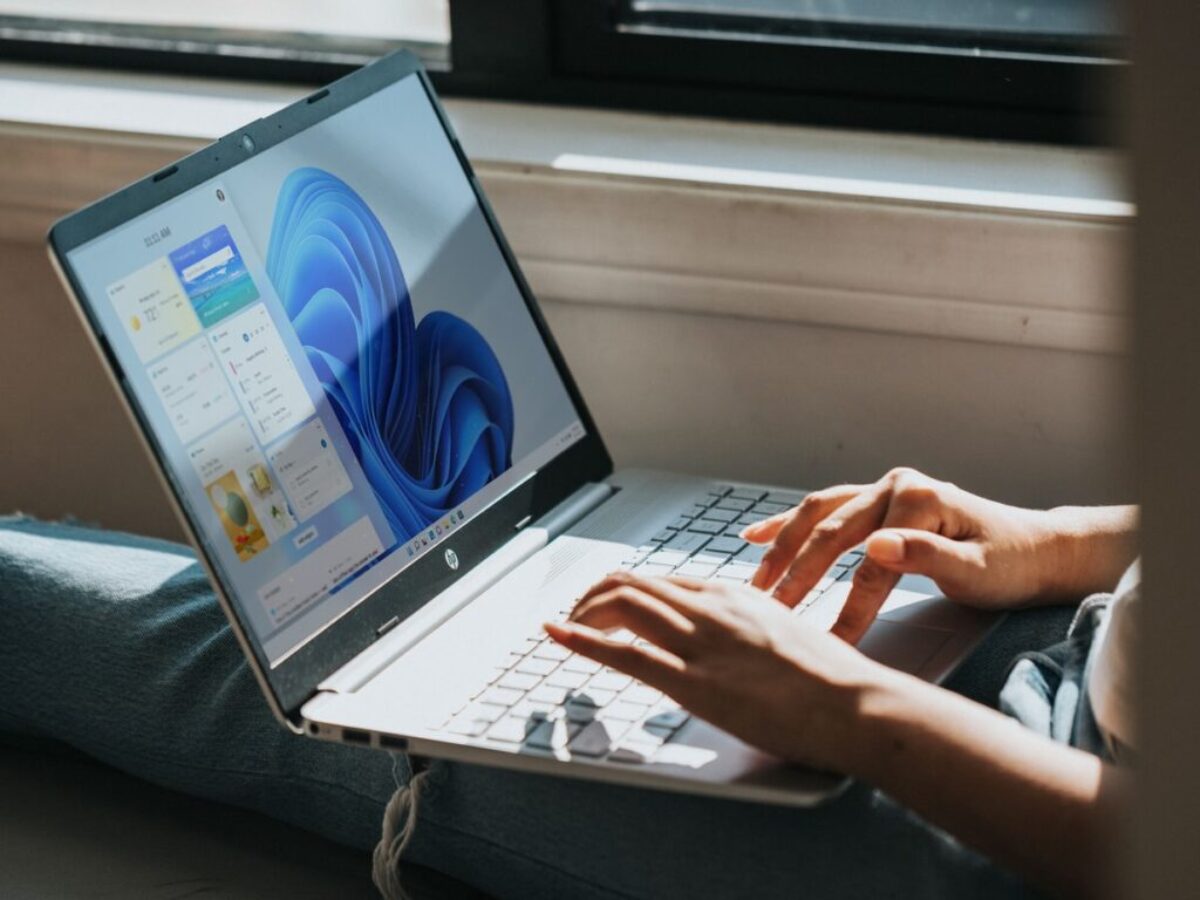 person using Windows 11 computer on lap